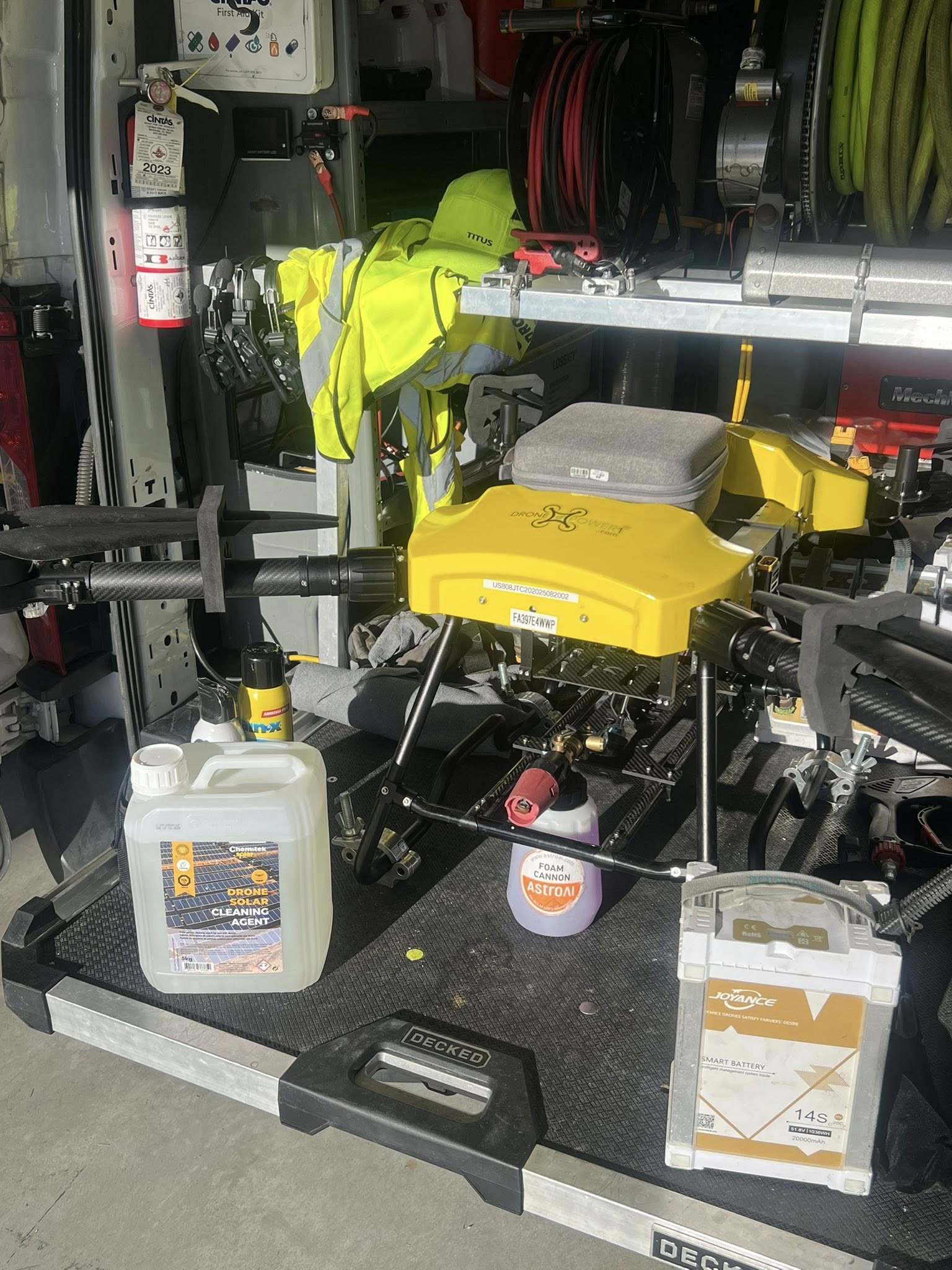 Drone passing over panels applying deionized water